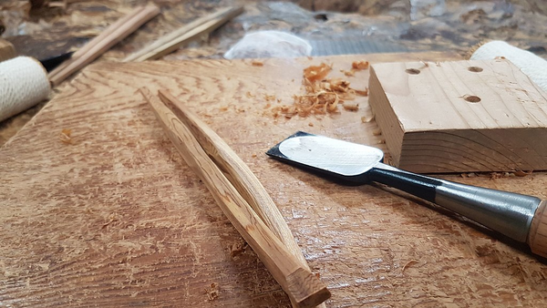 A woodworking worktop with some work-in-progress chopsticks
